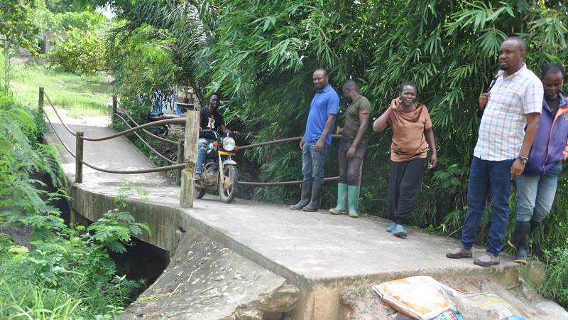 WAKAZI wa Mtaa wa Upendo Kata ya Saranga Wilaya ya Ubungo jijini Dar es Salaam wakipita katika daraja la Mbao ambalo linaonekana kumomonyoka na kutitia ambalo linasemekana kuwa limegharimu shilingi milioni 35 kwa mjibu wa wakazi wa eneo hilo.