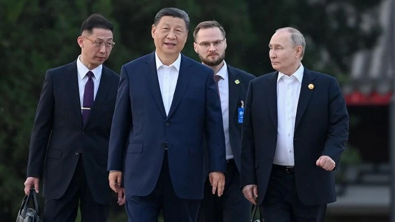 Chinese President Xi Jinping (front, left) talks with Russian President Vladimir Putin (right) as they meet at Zhongnanhai in Beijing, China, May 16, 2024.