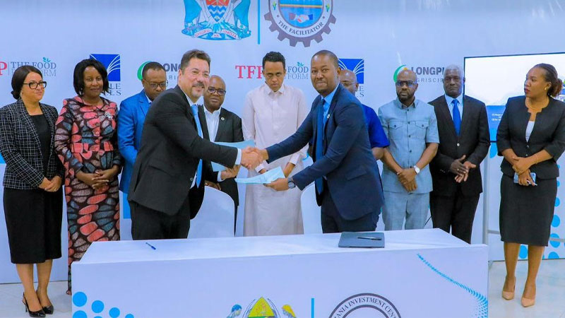 Tanzania Investment Center (TIC) Director General Gilead Teri (R) exchanging documents with the investor from  Food platform company, Ibrahim Qammar shortly after signing the agreement for the development of Mkulazi agriculture in Morogoro region.