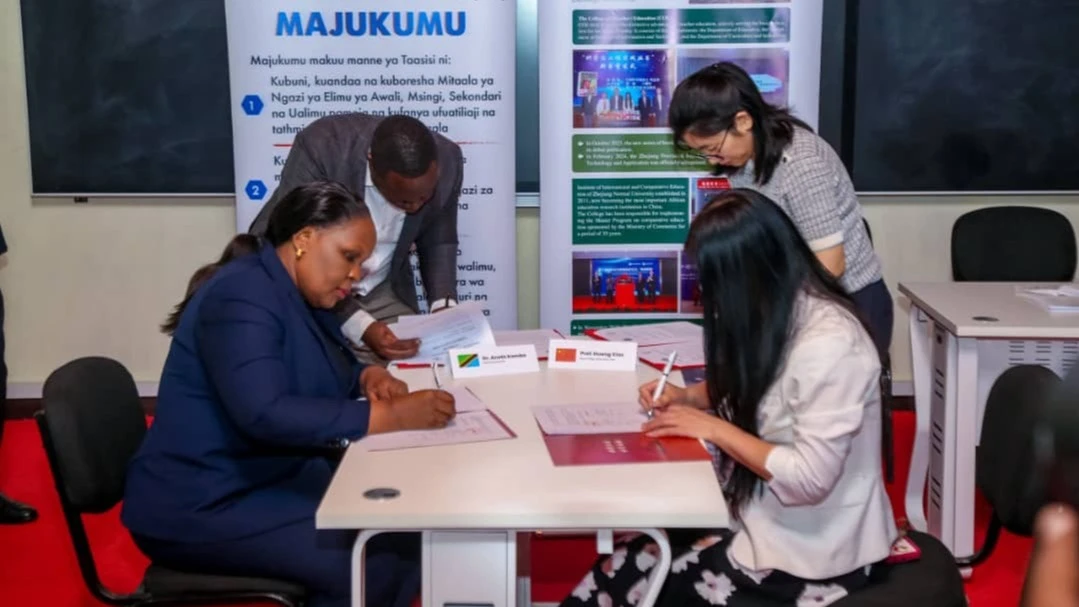 Dr. Aneth Komba, (L) director of the Tanzania Institute of Education (TET) Prof. Huang Xiao, (R) Head of Zhejiang Normal University (ZJNU) of China , signing cooperation agreement contract. 