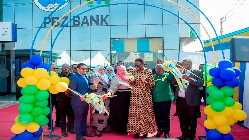 Speaker of the National Assembly Dr Tulia Ackson (3rd R), congratulated herself after cutting the ribbon to inaugurate the new branch of the People's Bank of Zanzibar (PBZ) in Mbeya Region.