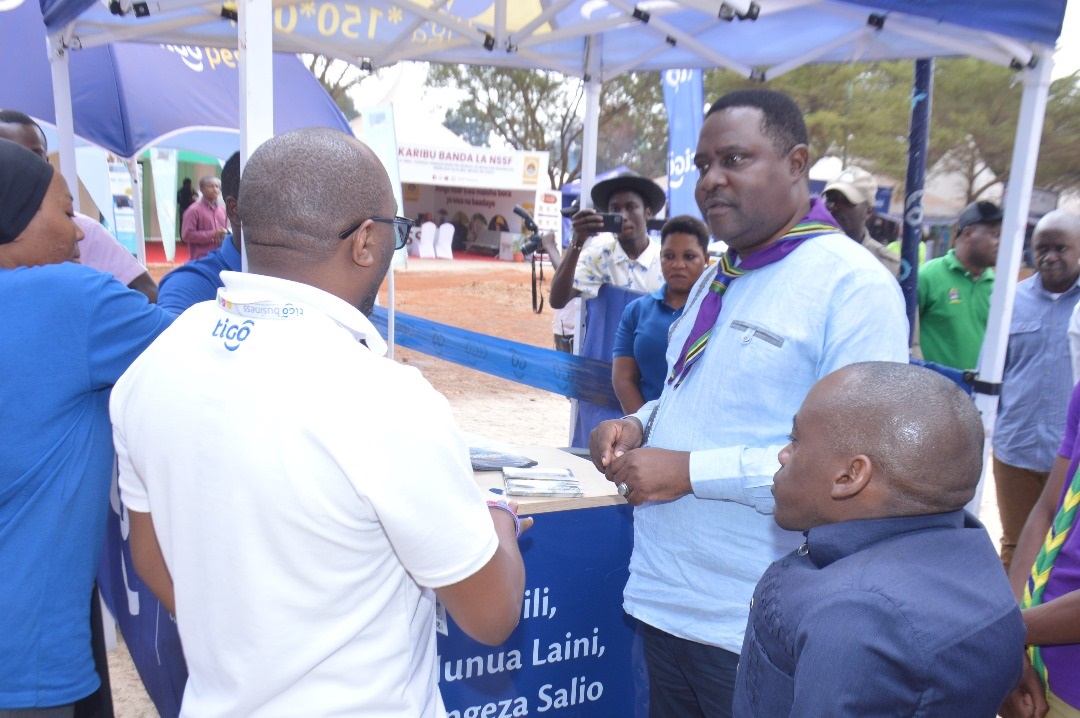 Aboubakar Kunenge (R), the Coast regional commissioner, visits the TiGo booth at the Nane Nane grounds in Morogoro yesterday. 