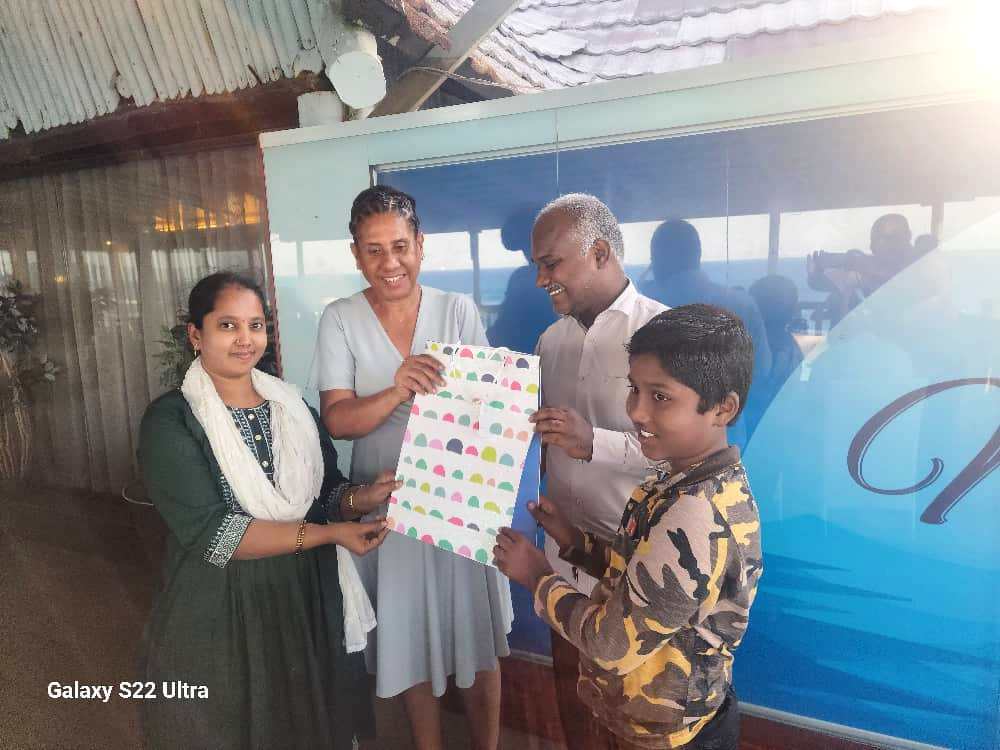 3.	Beatrice Bandawe (2nd L), the Nipashe newspaper managing editor, presents a gift to TGL operations manager Murugan Vajran and his spouse.