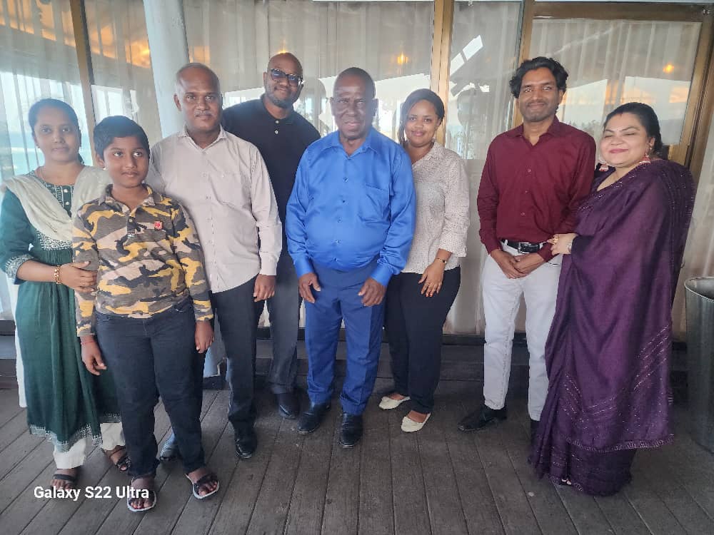 5.	IPP Executive Chairman Abdiel Mengi (4th L) poses in a group photo with The Guardian newspaper managing editor Wallace Mauggo (4th R), along with former TGL commercial director Ajay Goyal (2nd R), his wife (R) and former TGL operations manager Murugan 