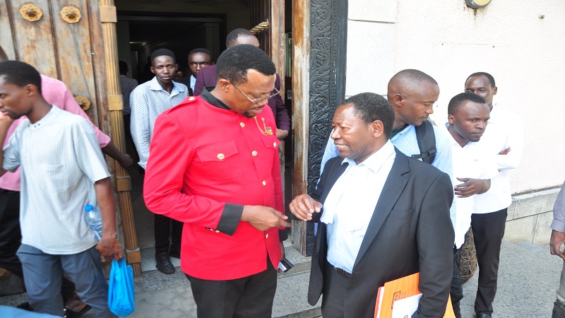 Kisesa MP Luhaga Mpina (L), speaks with advocate Rugemeleeza Nshala, after attending a court session at the High Court chambers in Dar es Salaam yesterday