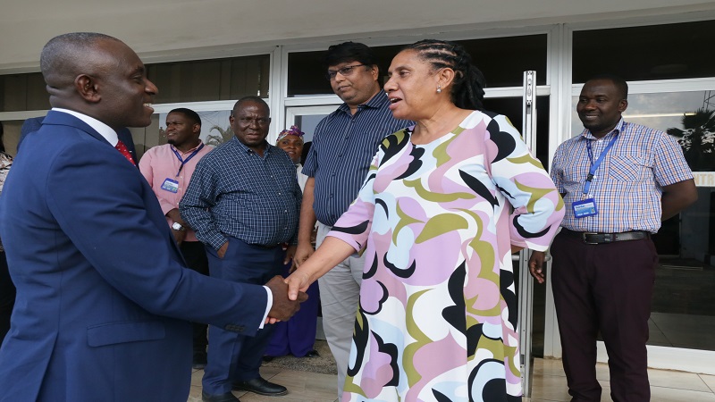 Dr Charles Asiedu exchanges greetings with Nipashe newspaper managing editor Beatrice Bandawe.