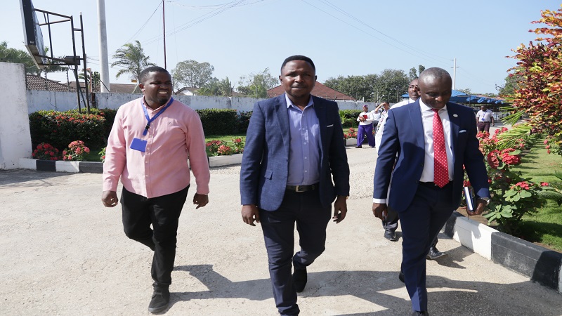 TGL deputy managing director Jackson Paul (C) leads the Ecobank Tanzania MD to the venue of a briefing session. Left is TGL marketing manager Weapon Mwajombe. 