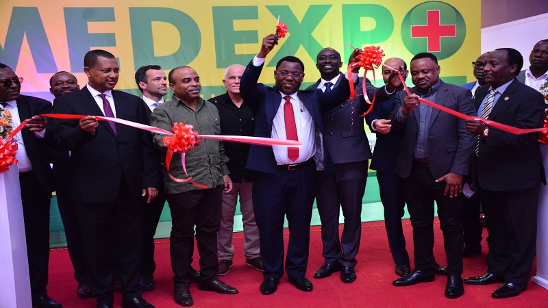 Muhimbili National Hospital Medical Services, Director Dr John Rwegasha (in red tie) cuts the ribbon in Dar es Salaam yesterday to open the 25th edition of the International Medical Equipment Exhibition (MEDEXPO). 