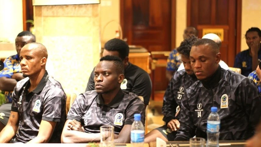 Taifa Stars players pictured on Sunday listening to the Minister of Culture, Arts and Sports, Dr Damas Ndumbalo (not in picture), when he visited their camp in Dar es Salaam.