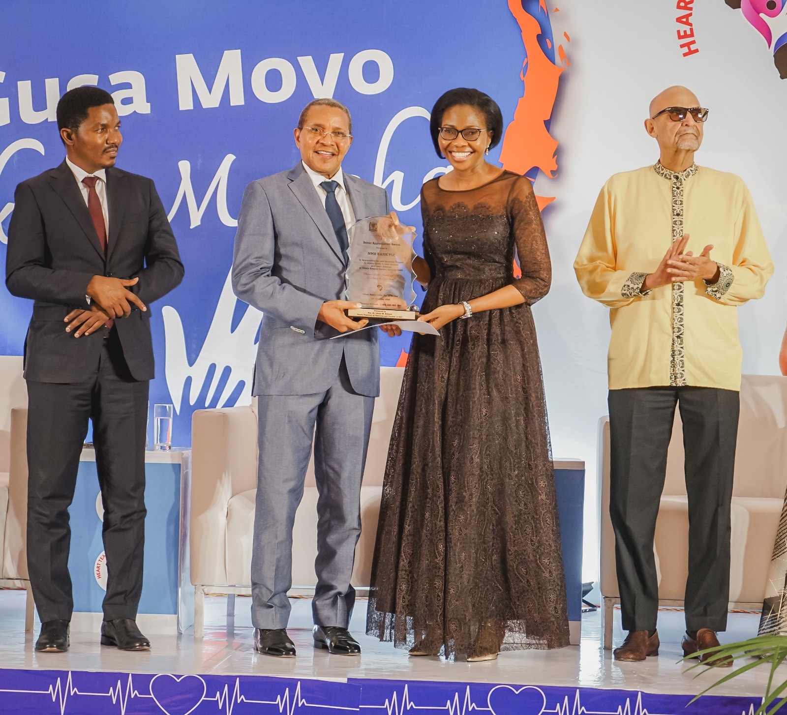 Former president Jakaya Kikwete pictured in Dar es Salaam at the weekend presenting an award and a certificate of appreciation to NMB Bank CEO Ruth Zaipuna (2nd-R) in acknowledgment of the bank’s contribution of 1bn/- 