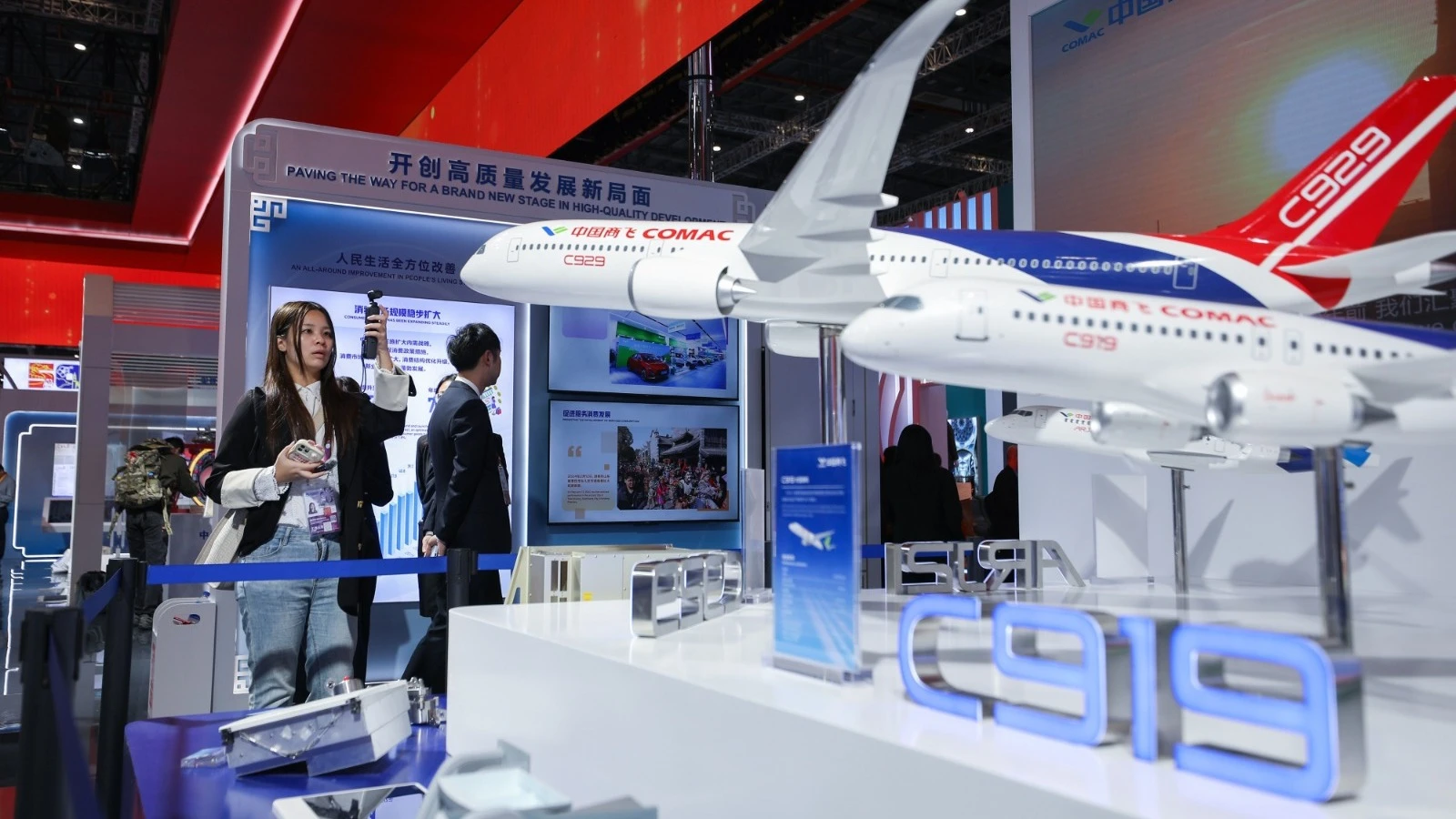 A visitor takes photos of a plane model at the China Pavilion of the 7th China International Import Expo (CIIE) in east China's Shanghai, Nov. 5, 2024. 