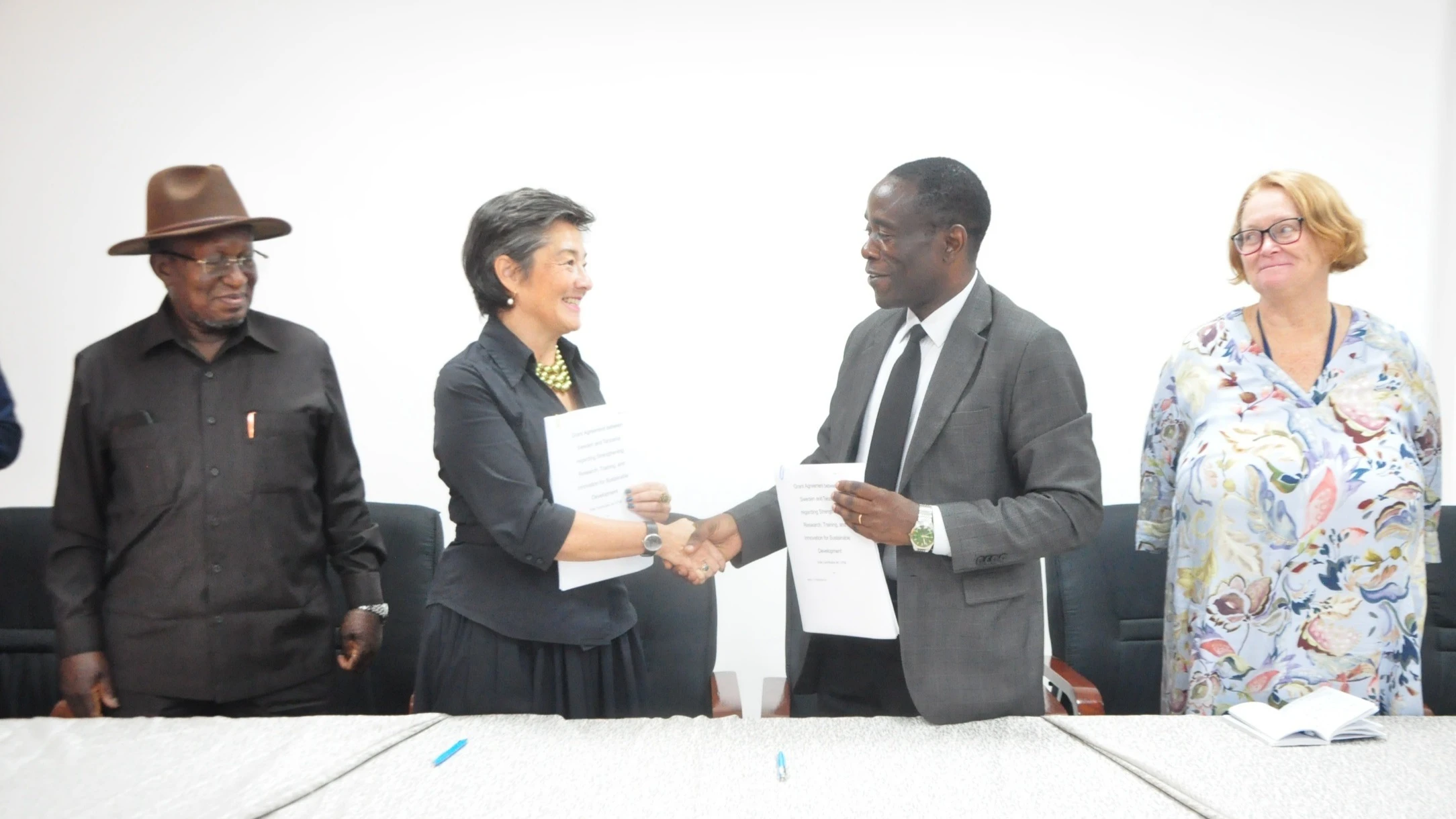 Muhimbili University of Health and Allied Sciences (MUHAS) vice chancellor Prof Apolinary Kamuhabwa (2nd-R) and Sweden’s Ambassador to Tanzania, Charlotta-Ozaki Macias, exchange documents in Da es Salaam yesterday shortly after signing 12.5bn/- agreement.