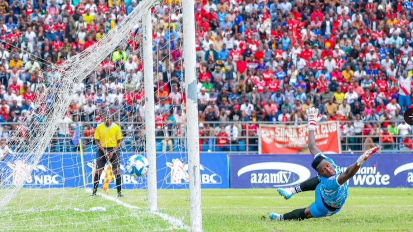 Pamba Jiji goalkeeper Amos Yona fails to stop a penalty shot from Simba striker Leonel Ateba during their Premier League match held at Kirumba Stadium yesterday. 