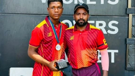 Aces A cricket team's youthful performer Hamza Ally (L) receives the Player of the Match prize from teammate Abhishek Kumar after the squad faced Delaware Upanga SC in the 2024 Tanzania Cricket Association (TCA) Delaware Champions League 