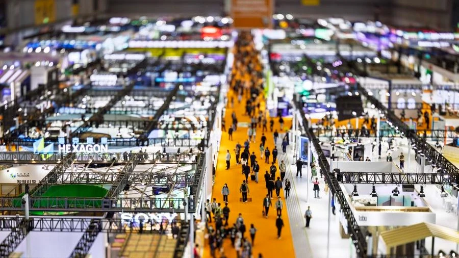 This photo taken with a tilt-shift lens on Nov. 9, 2024 shows people visiting the exhibition area of Intelligent Industry and Information Technology during the 7th China International Import Expo (CIIE) in east China's Shanghai.