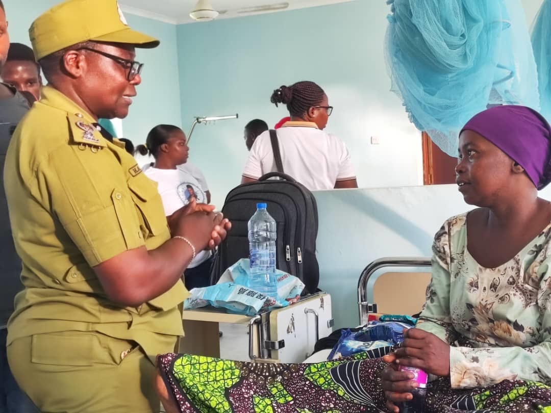 Hadija Sokolo (L), the chairperson of the Women’s Police Network’s in Tanga Region, has a word at the weekend with one of the patients admitted to Pangani District Hospital. 