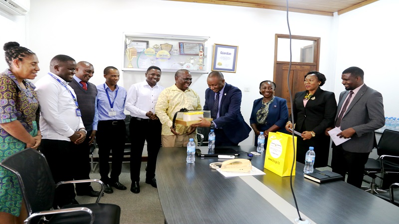 MANY THANKS FOR YOUR SUPPORT…: Tanzania Revenue Authority’s Taxpayer Education manager, Paul Walalaze (4th-R), presents a cake to The Guardian newspaper managing editor Wallace Mauggo, who received it on behalf of the newspaper publishing company. 