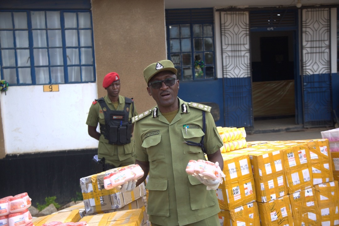 Songwe Regional Police Commander Augustino Senga displays some of what he said were banned imported cosmetics impounded during a police crackdown at Keseria in Chapwa ward, Momba District, on Saturday that saw several suspects arrested.