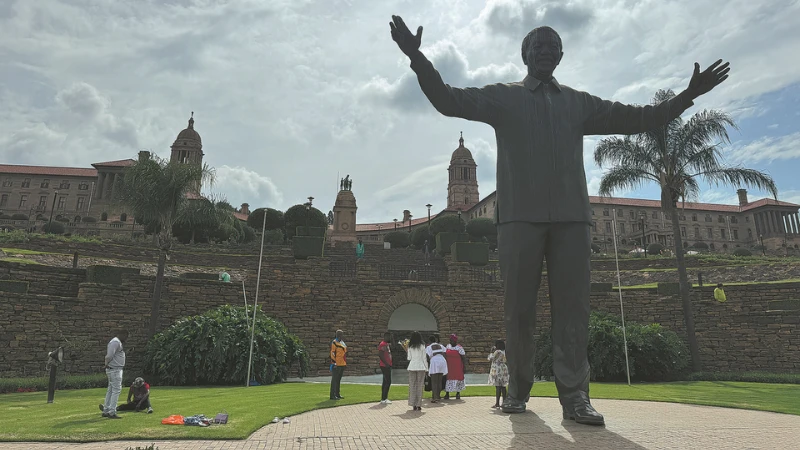 Visitors explore the Union Buildings in Pretoria, South Africa, on April 15. The Nelson Mandela statue in front of the president's office has become a popular attraction for tourists. 