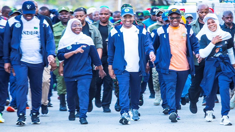 President of Zanzibar Dr. Hussein Ali Mwinyi (C) enjoying a moment with Naima Said Shaame (R), a financial institutions officials, at a walk to mark the national exercise day in Wete District, Pemba North Region. 