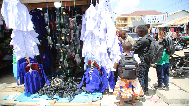 Parents and their children select school uniforms as part of preparations for the new school year at One Way area in Dodoma city over the weekend. 