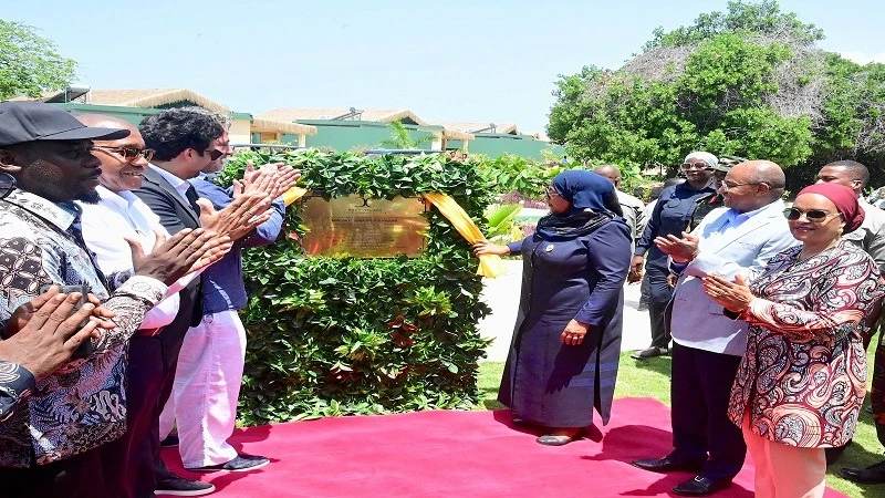 President Samia Suluhu Hassan draws a curtain with Andrea Azzola, the hotel investor at Bawe Island in Zanzibar, to launch the hotel, as part of events to mark 61 years of the Zanzibar Revolution yesterday. 