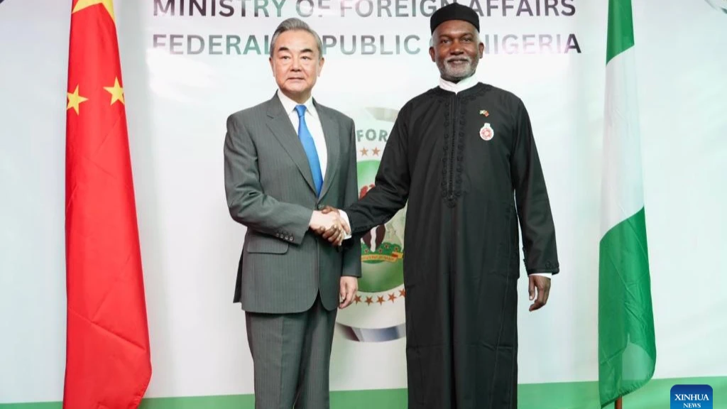 Chinese Foreign Minister Wang Yi (L), also a member of the Political Bureau of the Communist Party of China Central Committee, shakes hands with Nigerian Foreign Minister Yusuf Tuggar during their meeting in Abuja, Nigeria, on Jan. 9, 2025.