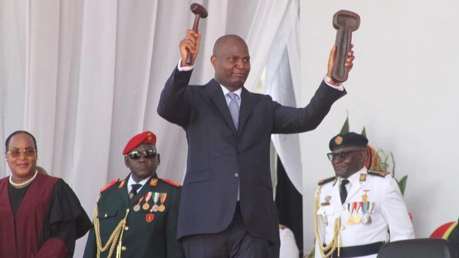 The newly sworn-in President of Mozambique Daniel Francisco Chapo demonstrates the symbol of power he received from Lucia Ribeiro, president of the Constitutional Council, during an inauguration ceremony in Maputo, Mozambique, on Jan. 15, 2025.