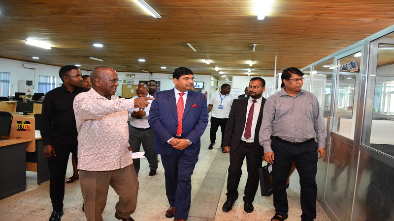 High Commissioner Bishwadip Dey (C) listens a briefing from Managing Editor Wallace Mauggo at the newsroom.