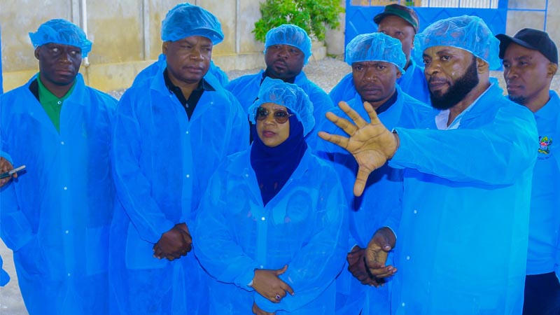 Minister for Livestock and Fisheries Dr. Ashatu Kijaji (C) listens a briefing from owner of Alpha Tanganyika Fish Processing Factory, Alpha Nondo (R), during her visit to the factory in Rukwa Region at the weekend.