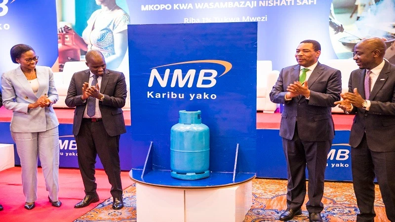 Deputy Prime Minister and Minister for Energy, Dr Doto Biteko (2nd L), claps shortly after launching NMB Bank’s loan facility to promote clean cooking in Dar es Salaam at the weekend. Others are Minister for Finance, Dr Mwigulu Nchemba (2nd R).