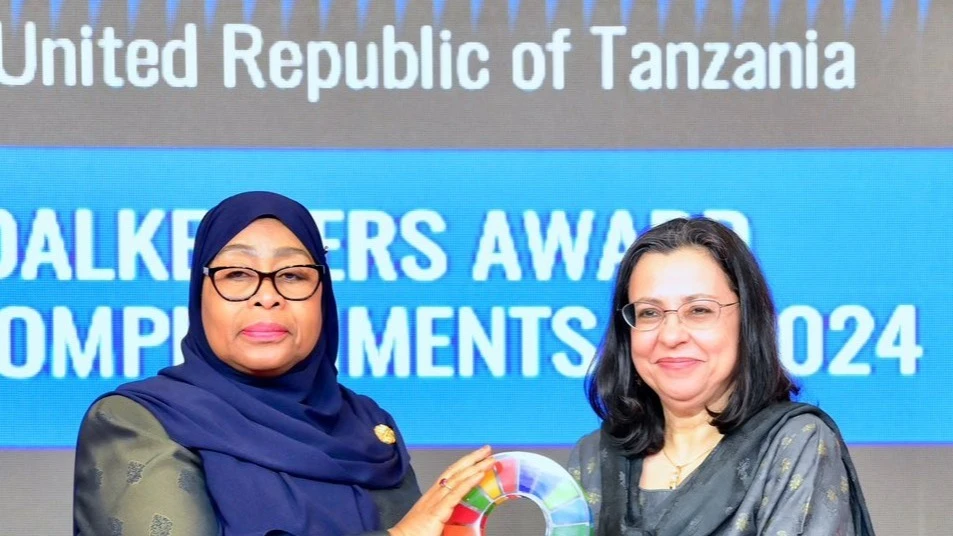 President Dr Samia Suluhu Hassan receives the prestigious international "Global Goalkeeper Award" from Dr. Anita Zaidi, President of the Gender Equality Division at the Gates Foundation, during a ceremony in Dar es Sa-laam yesterday. 