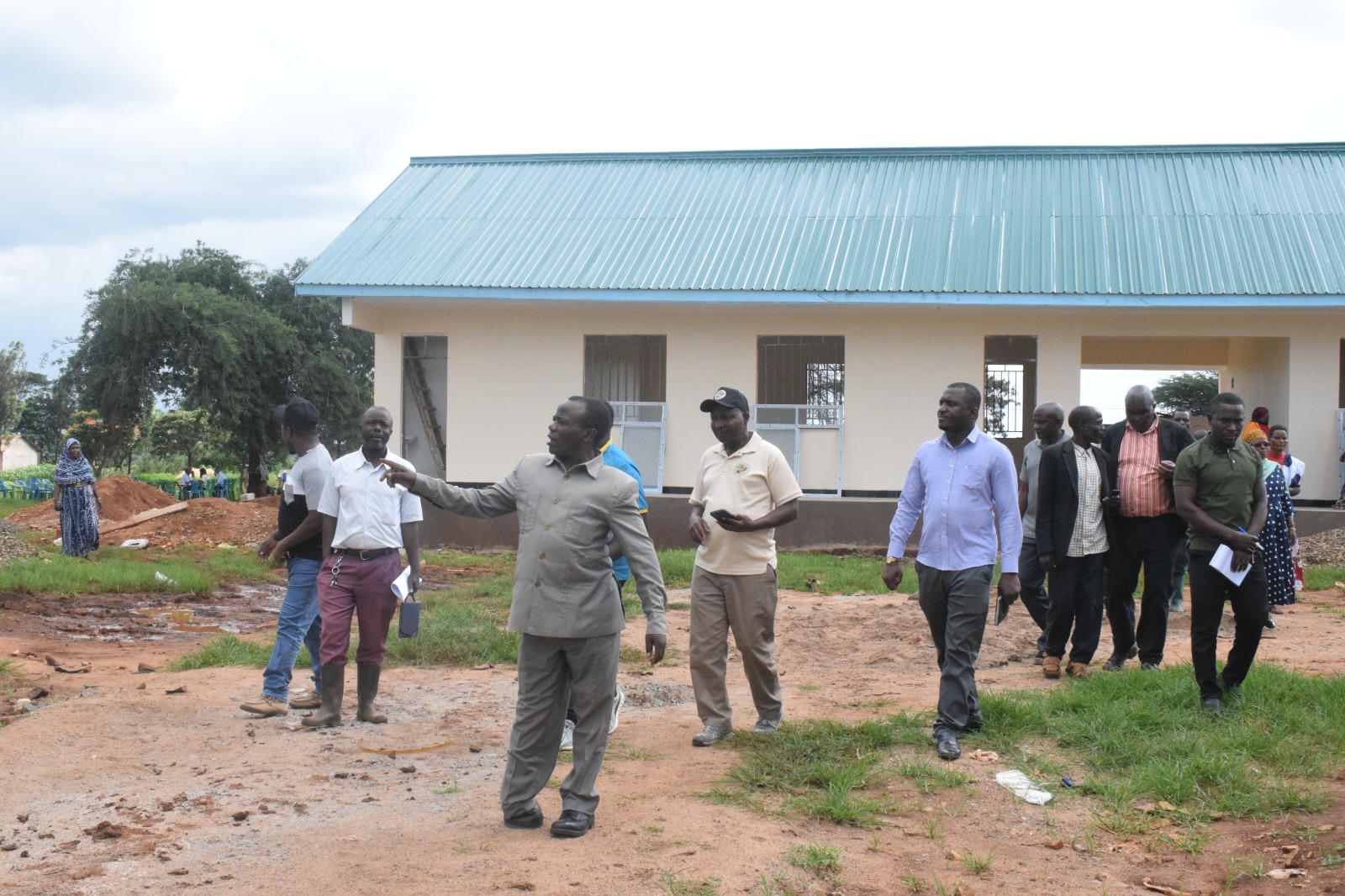 James Mkwega (front) Chairman of the Mkalama District Council in Singida Region leads members of the council’s Planning, Finance and Administration Committee during a visit to inspect the construction of Kidarafa Secondary School at Mwanga Ward in Mkalama