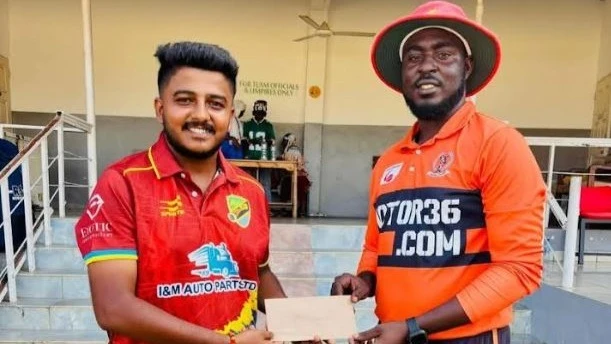 Aces A's cricketer Vishwas Nimavat (L) gets the Player of the Match prize from match umpire Nassor Zahoro once the former's team locked horns with Gymkhana in the recent 2025 Tanzania Cricket Association (TCA) DC Super League encounter at Dar es Salaam's 