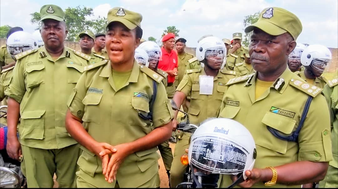 Assistant Police Inspector Faustina Ndunguru, who is also the Inspector of Mbwara Ward (2nd L), provides an explanation before welcoming the Rufiji District Police Commander, SACP Protas Mutayoba (R) to speak after distributing helmets to officers