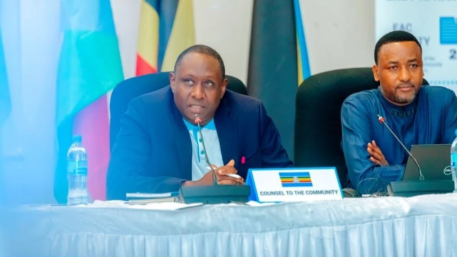 Dr. Anthony Kafumbe, the Counsel to the Community (CTC) makes his remarks as the EAC Secretariat Director of Productive Sectors Mr. Jean Baptiste Havugimana looks on