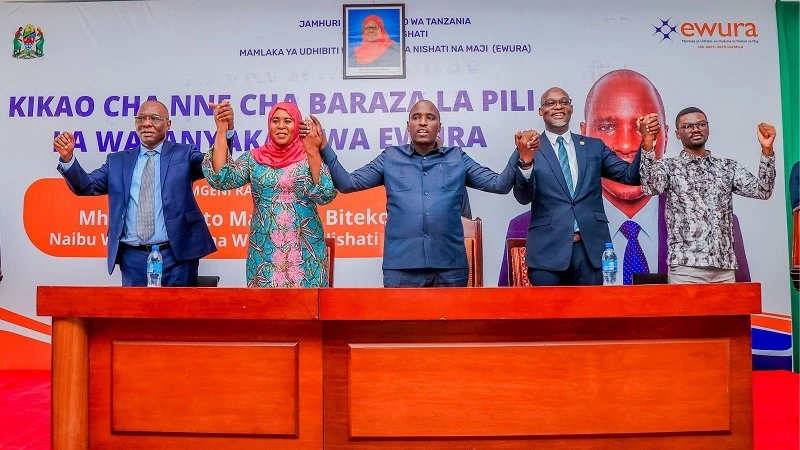 Deputy Prime Minister Dr. Dotto Biteko (C) holds hands with Tanga Regional Commissioner Dr. Batilda (2nd L) and Ewura Director General Dr. James Andilile (2nd R) at the opening of EWURA's Fourth Session of the Second Workers' Council in Tanga this week.