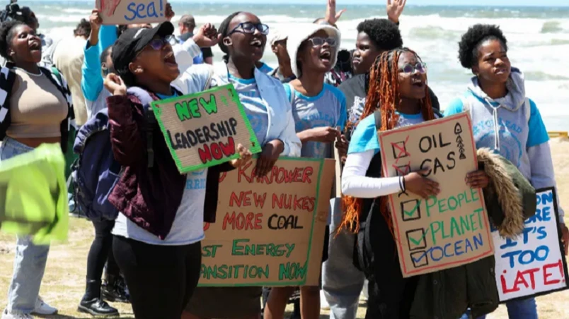 Climate activists hold placards as they demonstrate, calling for climate justice resistance against oil and gas drilling off the South African coastlines

 