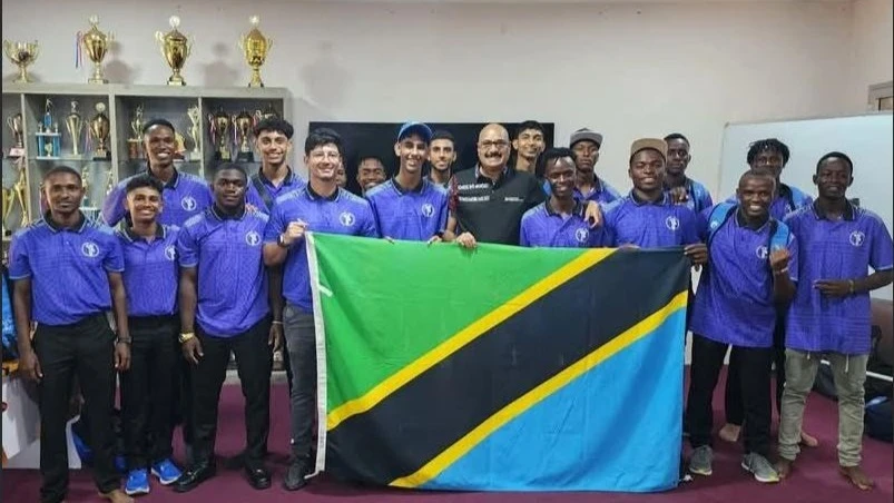 Tanzania Cricket Association (TCA) Chairman Balakrishna Sreekumar (in black outfit), poses for a photo with Tanzania's U-19 men's cricket squad when the association bade the team farewell in Dar es Salaam last weekend. The cricketers will feature in the 2