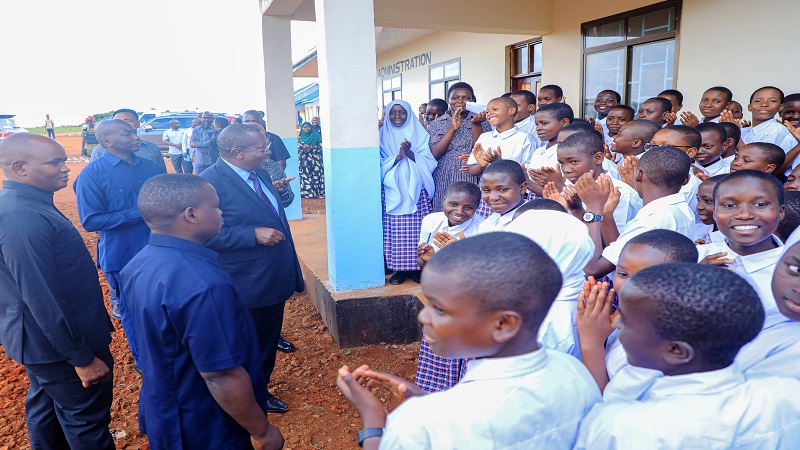 Vice President Dr. Philip Mpango speaks to first-year students of Kahimba Girls Secondary School in Buhigwe, Kigoma Region, during his visit to inspect the progress of the school's construction on Monday. 