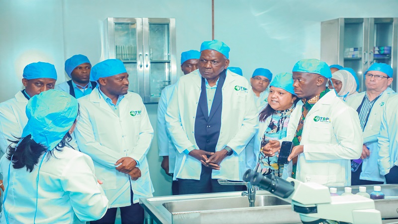 Cuban Parliament President Esteban Hernandez (C) learns about mosquito pesticide production at Tanzania Biotech Product Company (TBPL), a Cuba-Tanzania joint venture under NDC.