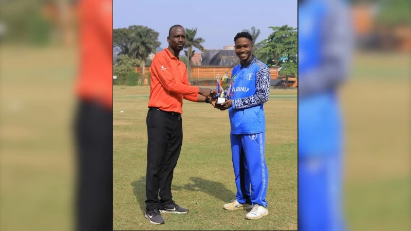 Tanzania's U-19 men's cricket squad's Mohamed Simba (R) gets the Player of the Match prize from the match umpire when the side confronted the Uganda U-19 squad in the 2025 Easter Youth ODI Series clash in Kampala last Sunday.