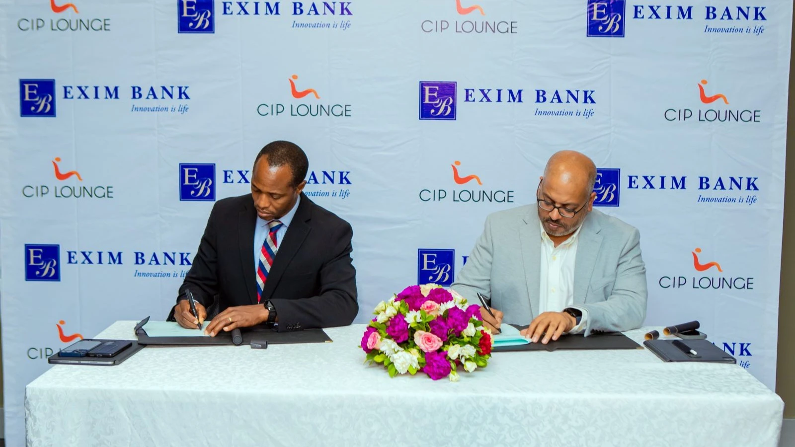 Exim Bank's Chief Financial Officer, Shani Kinswaga (left), and Dough Works Limited’s Director, operators of CIP Lounge, Vikram Desai, sign a partnership agreement to offer exclusive benefits to their customers at the CIP Lounge at Julius Nyerere Internat