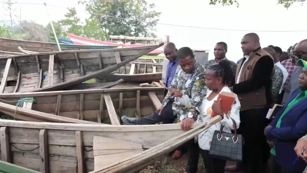 The then Livestock and Fisheries Minister, Abdallah Ulega(first row, Center) during a visit at one of the fishing beaches in Kagera Region. 