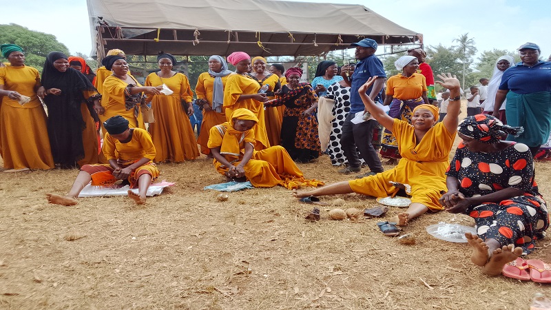  Entrepreneur woman from the Kilometa Group, based at Kilometa Village in Muheza District known as Mama Shaa, joyfully raising her hands in celebration after winning the coconut plucking competition