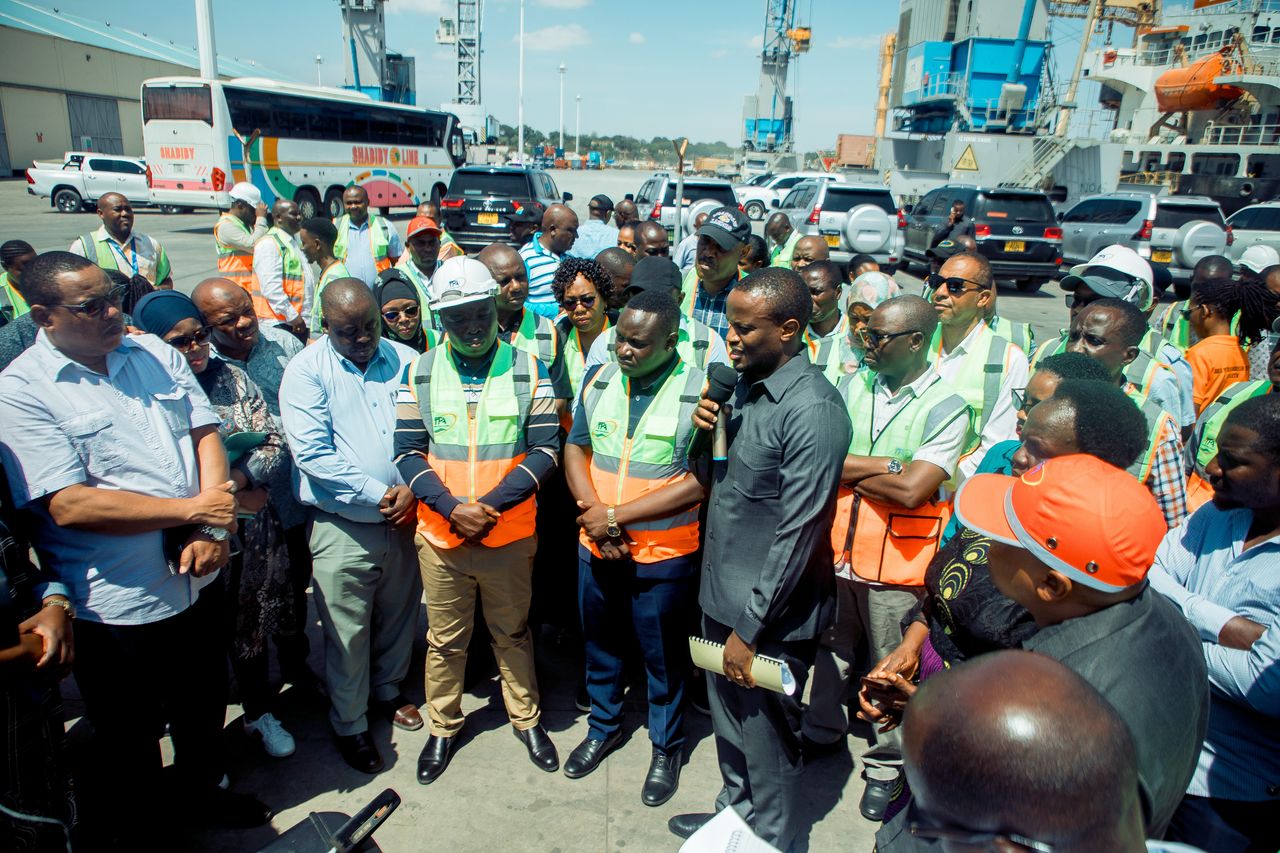 Tanzania Ports Authority Director General Plasduce Mbossa (with black suit), speaks to members of the Parliamentary Standing Committee on Infrastructure who visited Tanga Port yesterday