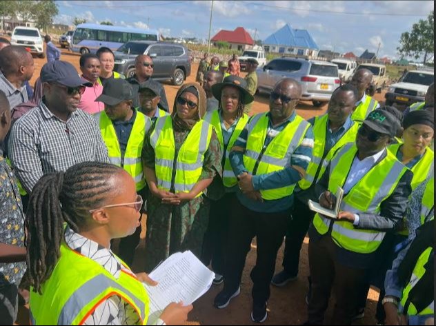 Road construction project coordinator Enne Moses (L) pictured in Shinyanga municipality yesterday briefing members of the Local Governments Parliamentary Standing Committee led by the committee’s chairman, Justin Nyamoga (R).