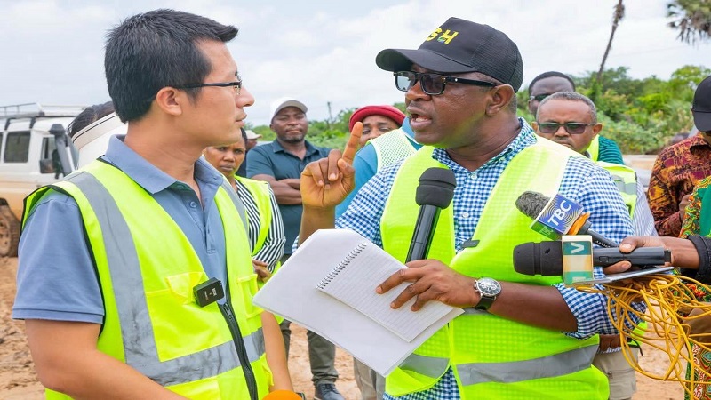 Works minister Abdallah Ulega (R) pictured in Tanga Region at the weekend having a word with a supervisor with the China Railway 15th Bureau Group Co., Ltd (CR15), which is implementing the Pangani-Mkange-Bagamoyo road project. 