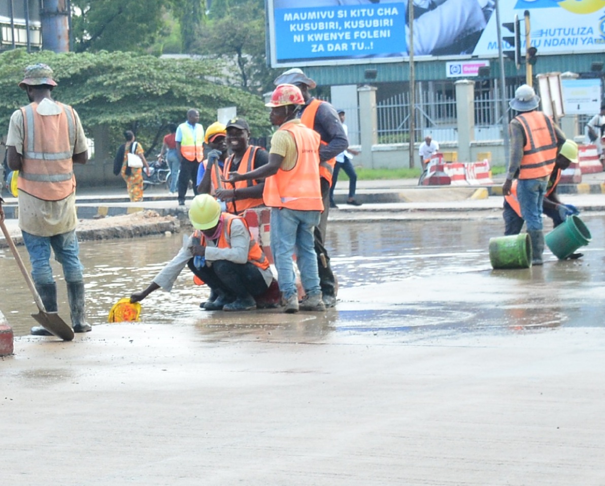 Workers of Dar Es Salaam Bus Rapid Transit construction project   remove stagnant water by using helmet along Bibi Titi Mohamed Road meant to proceed with their activities following the heavy rain occurred yesterday.