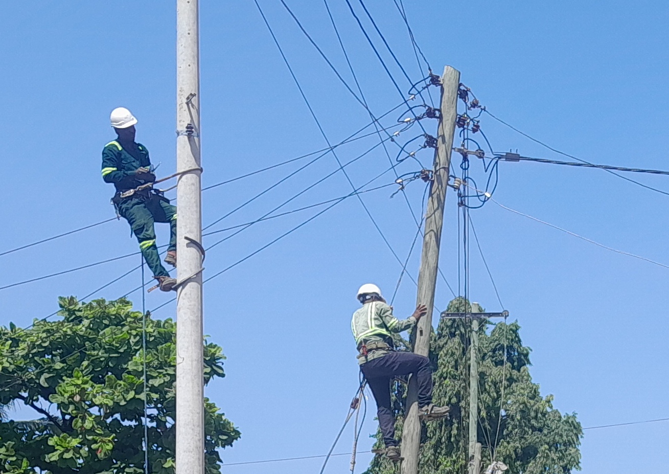 Electricians carry out maintenance on electricity infrastructure along Magomeni Mikumi Street in Dar es Salaam at the weekend. 